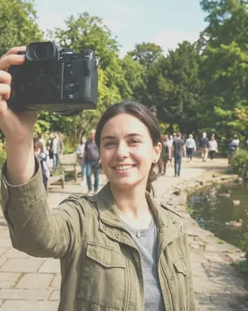 A fictional young woman taking a selfie in a park, clear day. With the Chrome Film preset applied.