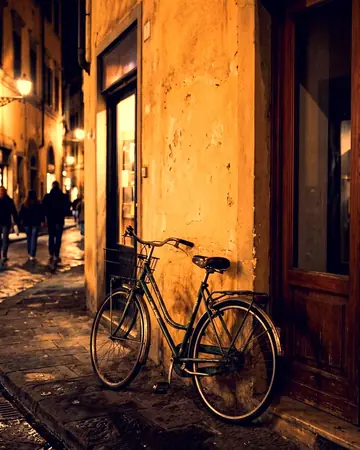 A bicycle leaning on a painted wall beside a doorway, night, lit only by street and shop lights. With the Night Halation preset applied.