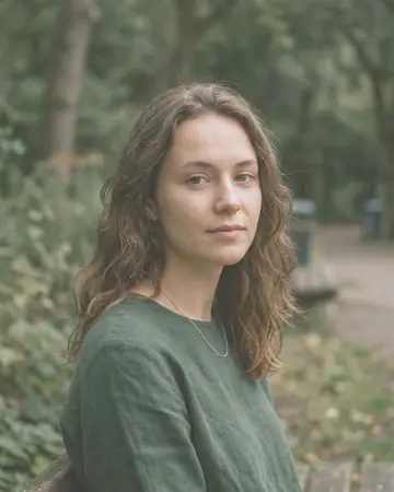 A fictional woman's portrait outdoors in open shade, daylight. With the Pastel Film preset applied.